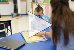 Teacher reading to a student