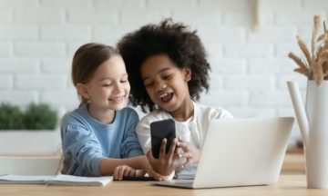image contains 2 girls on phone and laptop