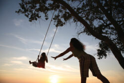 Girl being pushed on a swing