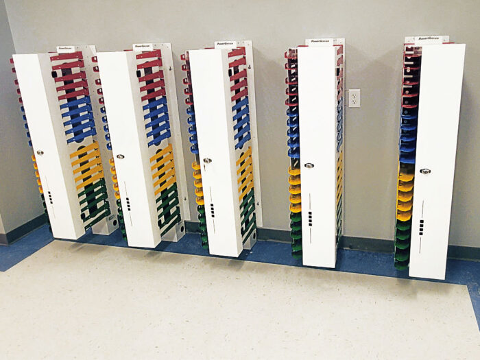 Image shows five PowerGistics charging stations mounted on a wall.