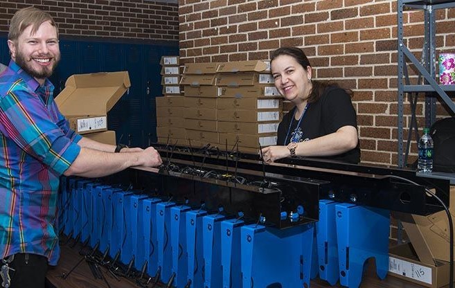 Image shows PowerGistics charging station being assembled by Barbers Hill staff