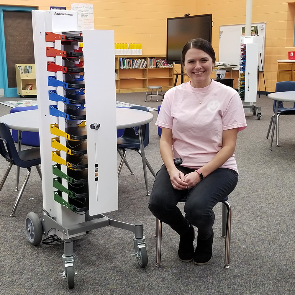 Image shows PowerGistics Core12 charging station on a Roller next to a female teacher