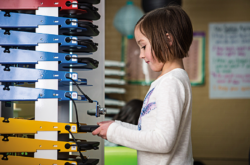 Image shows girl removing device from PowerGistics charging stations