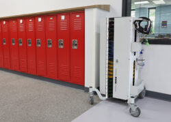 Image shows PowerGistics Flex20 charging Tower next to red lockers in school