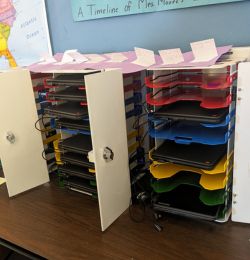 Image shows PowerGistics TableTower8 desktop charging stations in classroom