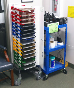 Image shows devices stored flat and charging in PowerGistics charging station